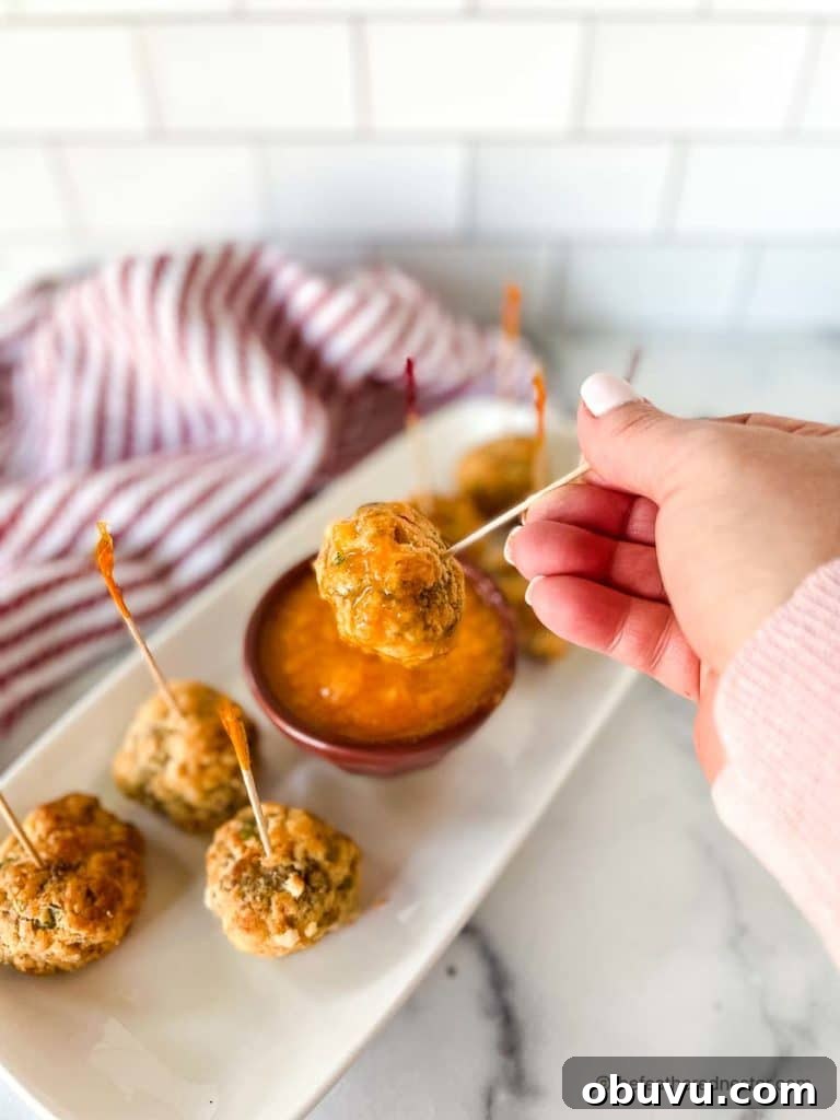 dipping an appetizer ball into mango sweet chili sauce.