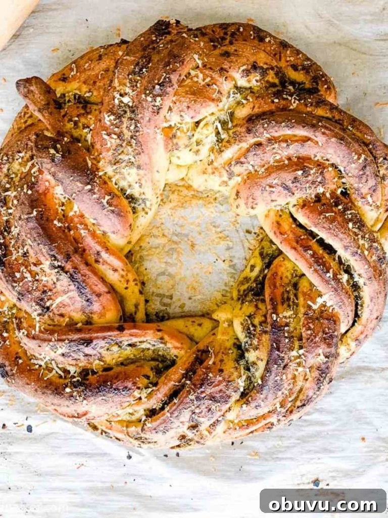 Twisted wreath of homemade pesto bread, ready for serving.