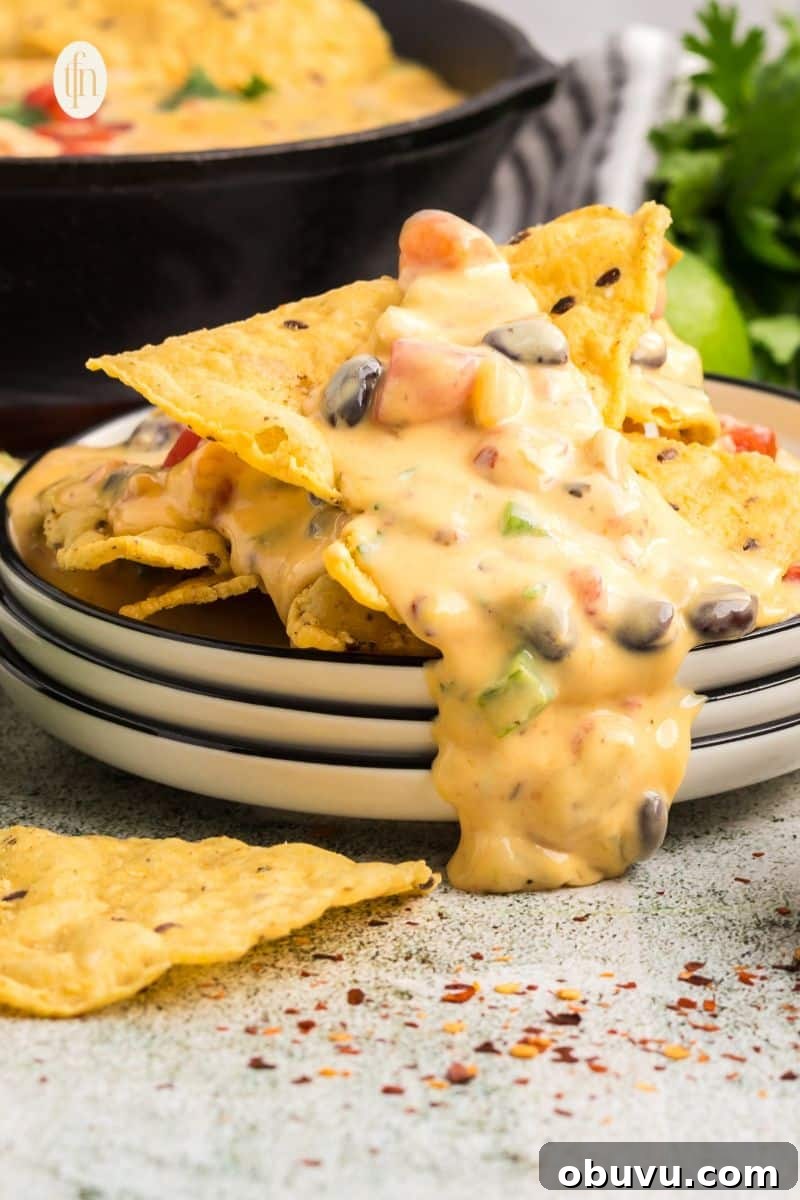 40+ Crowd-Pleasing Finger Food Ideas for Parties and Gatherings 4 Three stacks of plate with nachos on top.