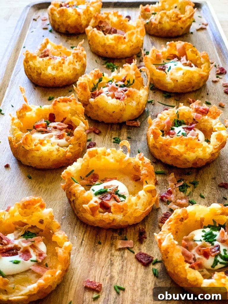 loaded tater tots placed in a wood serving tray.