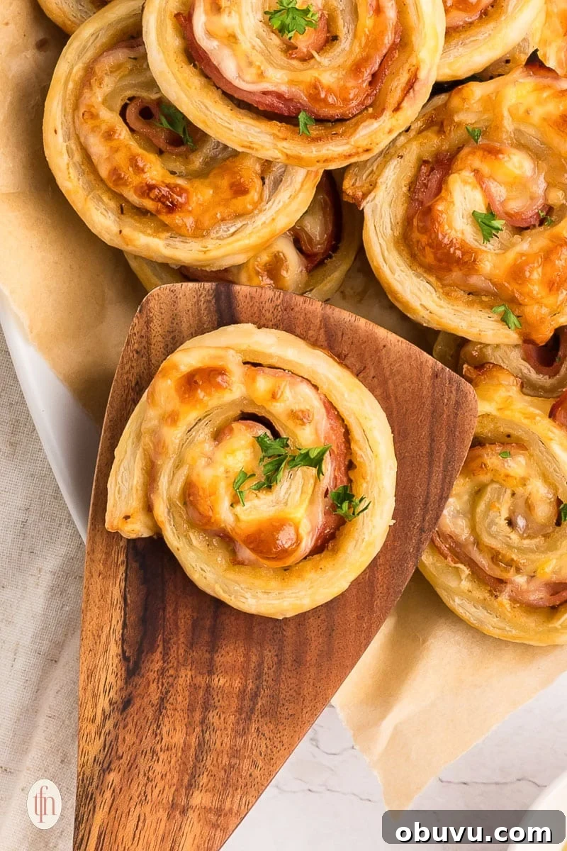 40+ Crowd-Pleasing Finger Food Ideas for Parties and Gatherings 47 finger food ideas showing ham and cheese pinwheels on serving platter