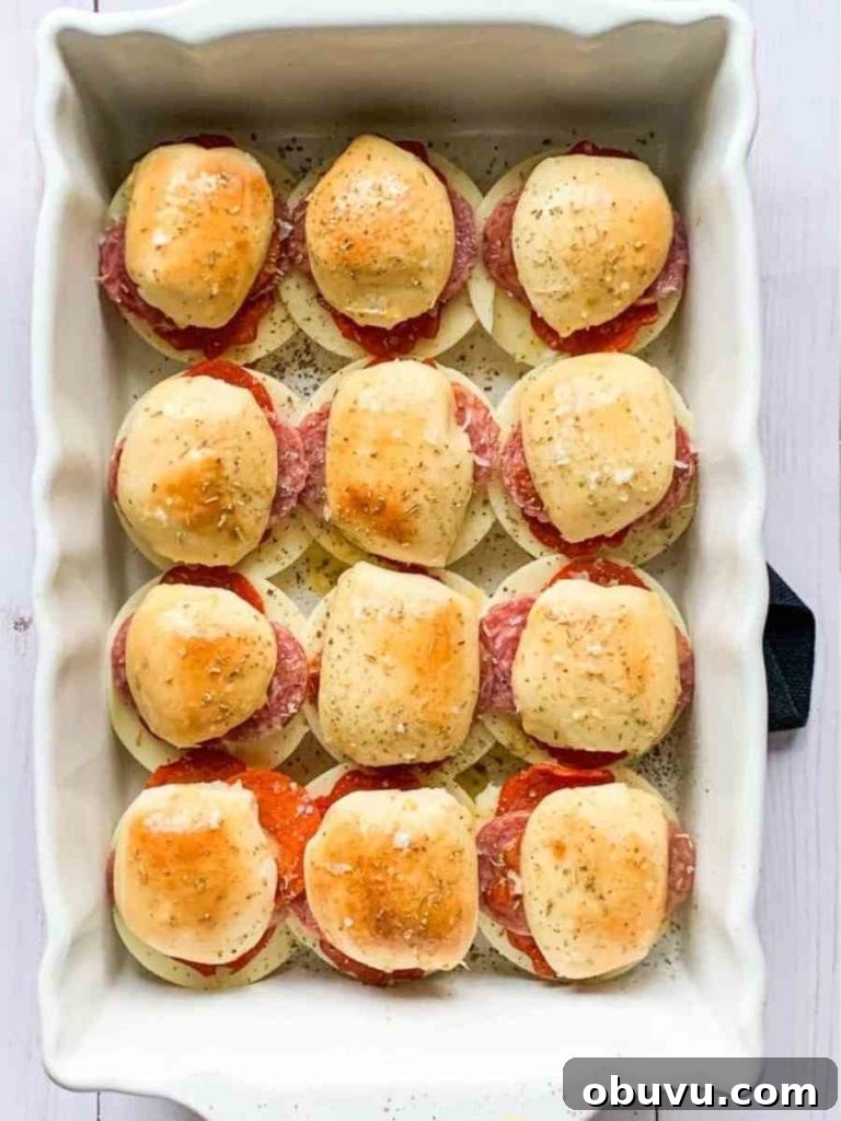 White baking dish filled with Italian sliders.