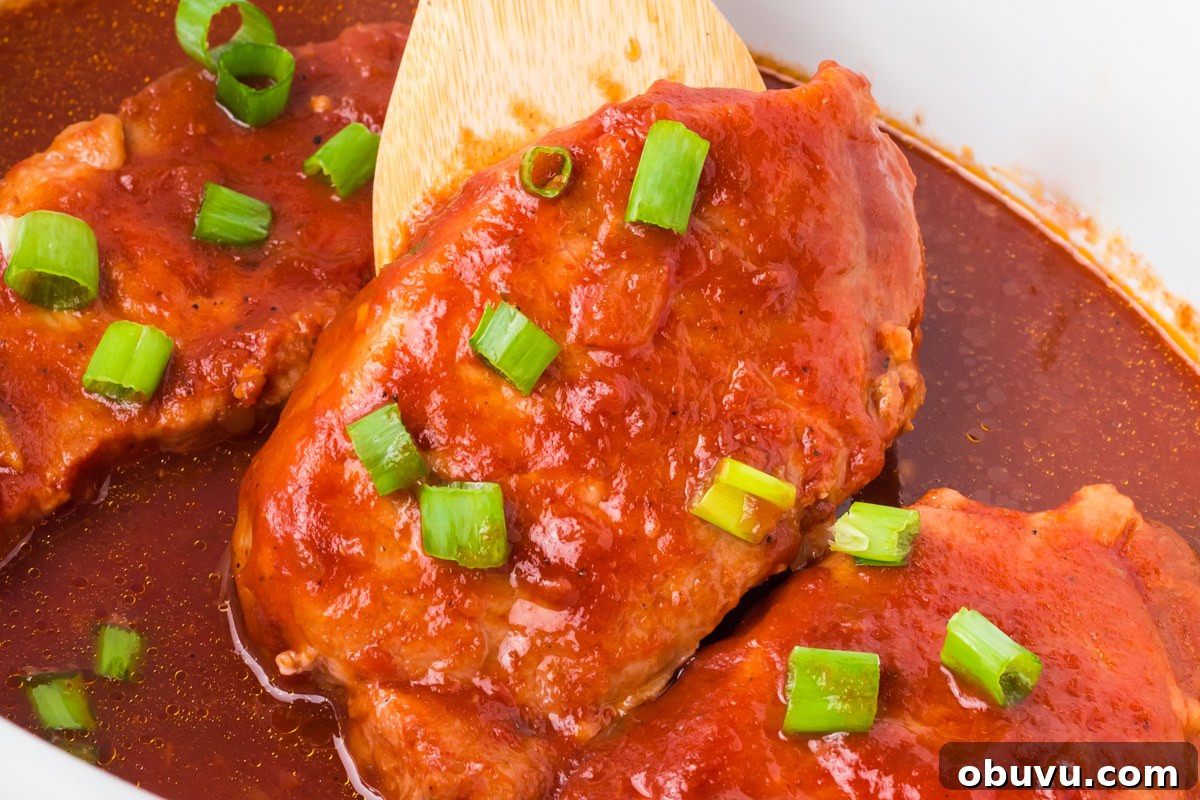 Tender Slow Cooker BBQ Pork Chops | Juicy, Hands-Off Recipe 5 close-up of slow cooker bbq pork chops.