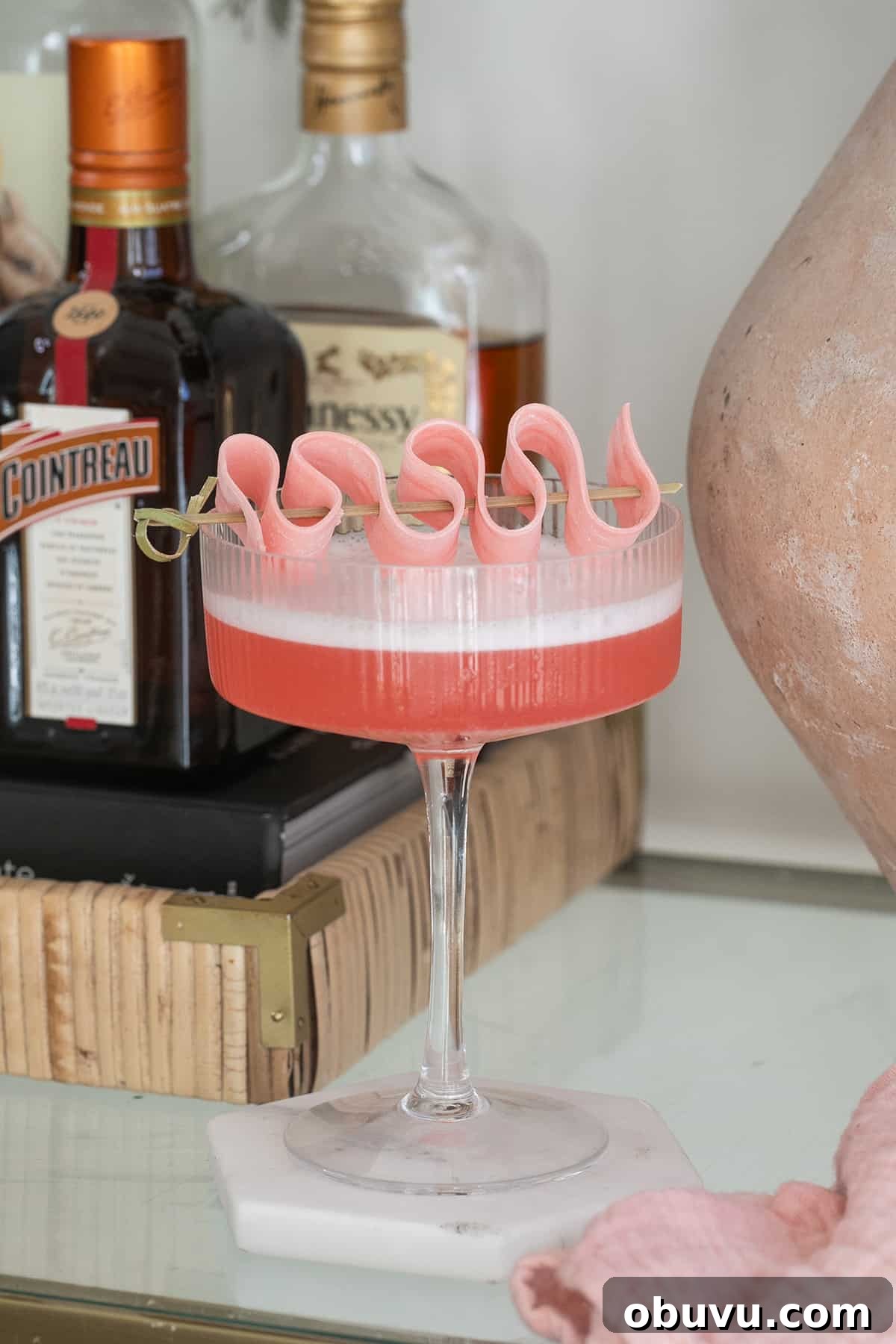 Bubble Gum Cocktail Recipe Using Infused Vodka 4 A pink cocktail made with bubble gum-infused vodka sitting on a bar cart.