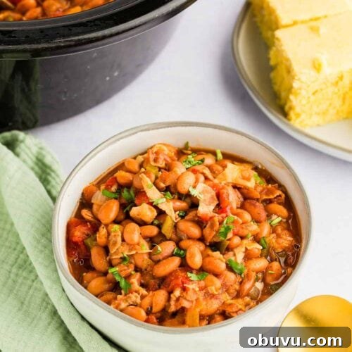 Slow Cooker Charro Beans served in bowl next to corn bread and slow cooker
