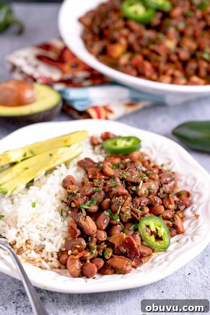Authentic Charro Beans Recipe (Ranchero Beans) 3 Mexican charo beans with bacon served with white rice and avocado slices