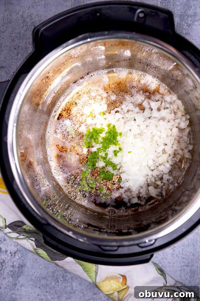 Authentic Charro Beans Recipe (Ranchero Beans) 7 cooking chopped onion and jalapeño pepper in the bacon fat