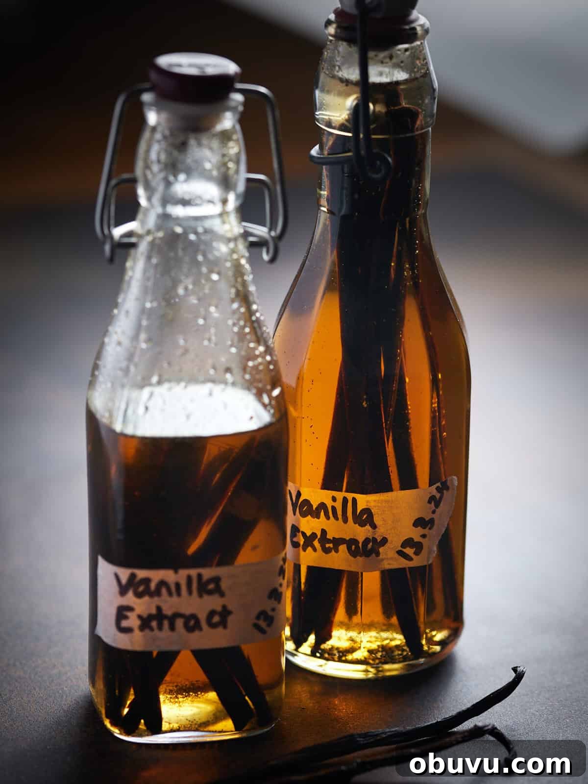 Alcohol-Free Homemade Vanilla Extract Recipe 8 Photo of two bottles of vanilla extract, with one half used while the other one is full behind.