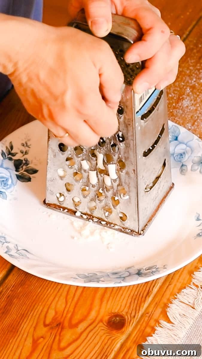 Make Your Own Laundry Soap: Simple DIY Recipe for Clean Clothes 7 Shredding the soap bar before melting it into the laundry soap.