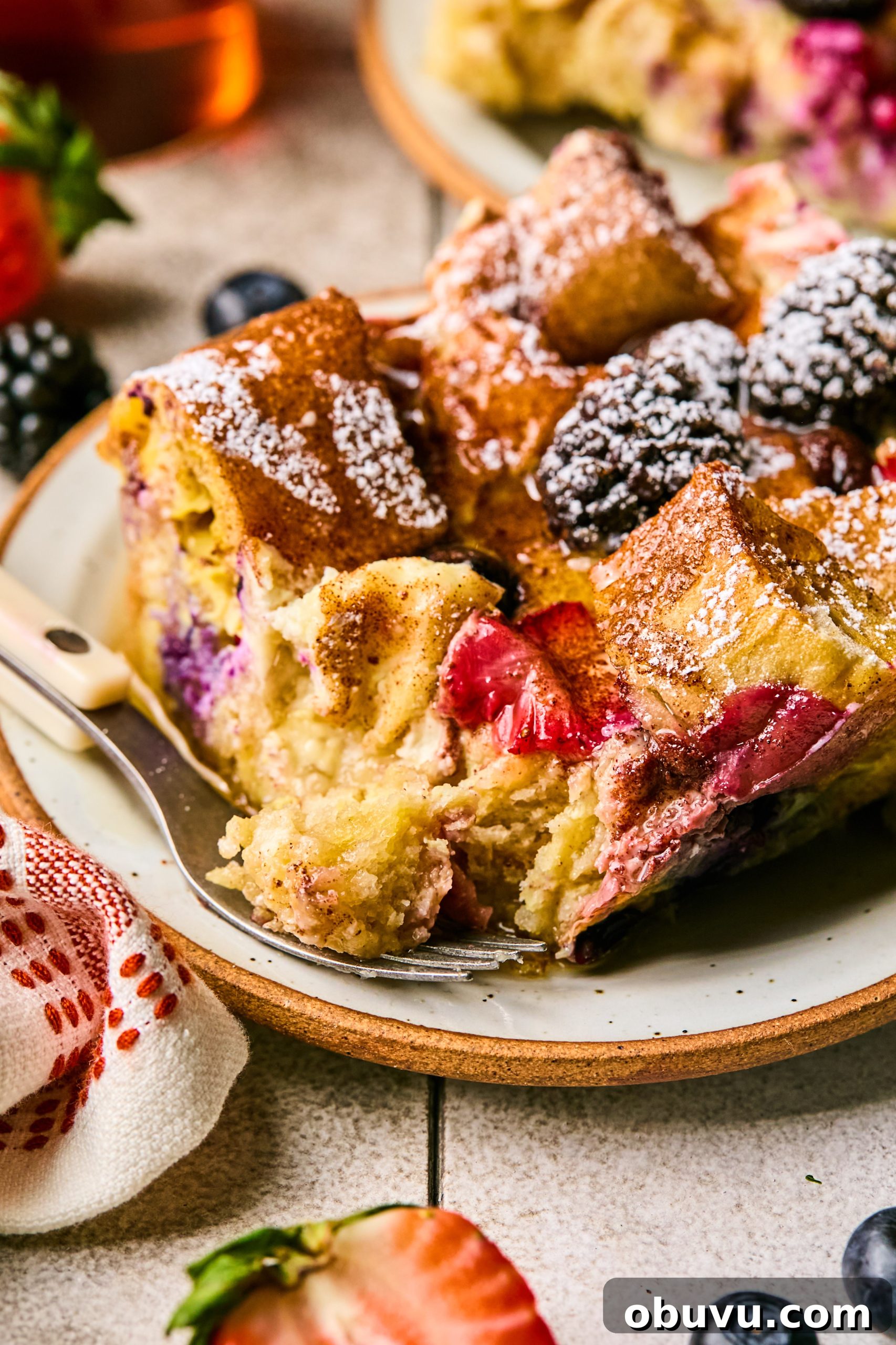 Berries and Cream French Toast Casserole Recipe 11 A close up photo of a slice of berries and cream french toast casserole