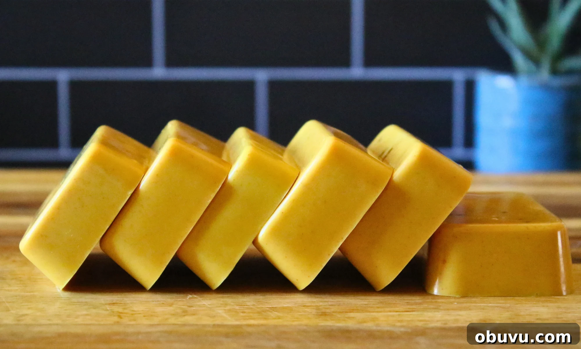Homemade Turmeric Melt-and-Pour Soap Recipe for Glowing Skin 2 Turmeric soap bars on a cutting board.
