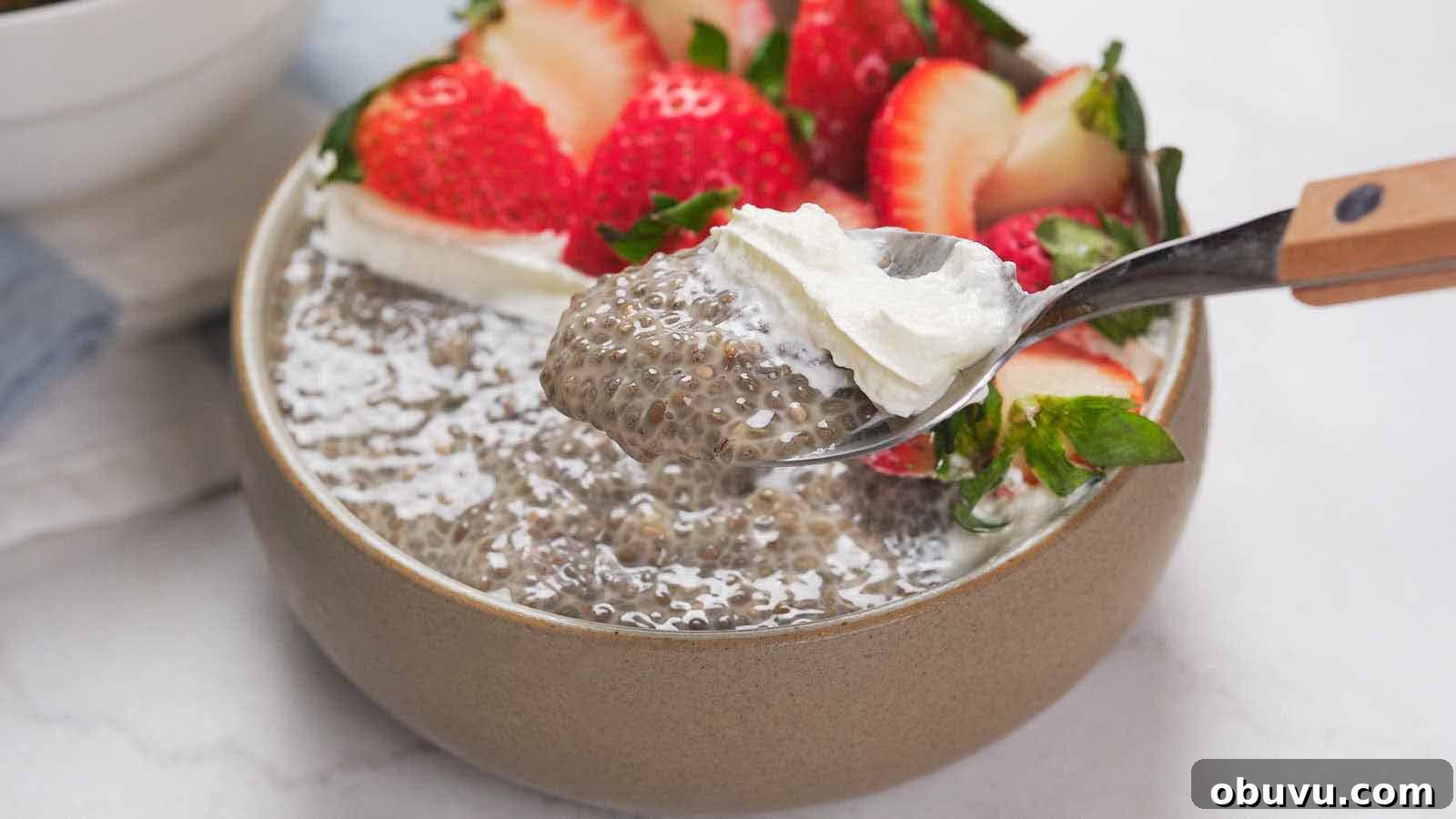 19 Cozy Low-Carb Breakfasts You’ll Crave Every Morning 12 A bowl of chia pudding topped with sliced strawberries and a dollop of whipped cream, with a spoon lifting a portion.
