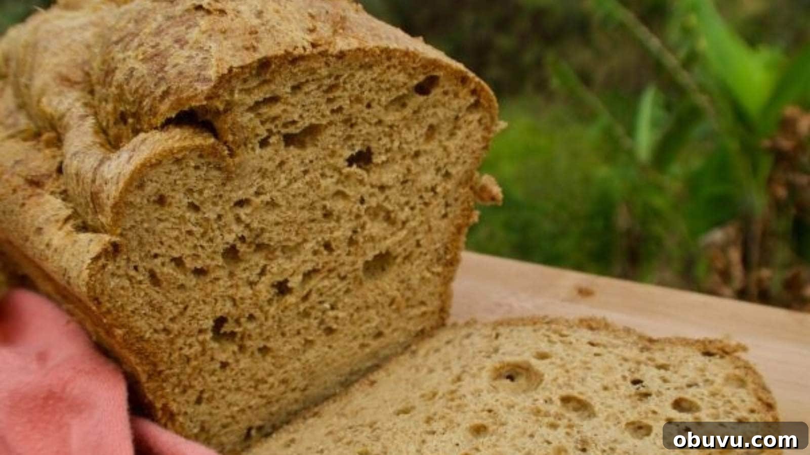 19 Cozy Low-Carb Breakfasts You’ll Crave Every Morning 4 A close-up of a loaf of bread with a slice cut off, placed on a wooden surface.