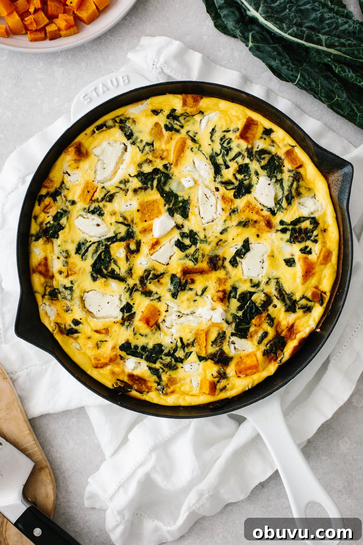 20 High-Protein Breakfast Recipes for Lasting Energy 11 Butternut squash frittata in a white saute pan on a table.
