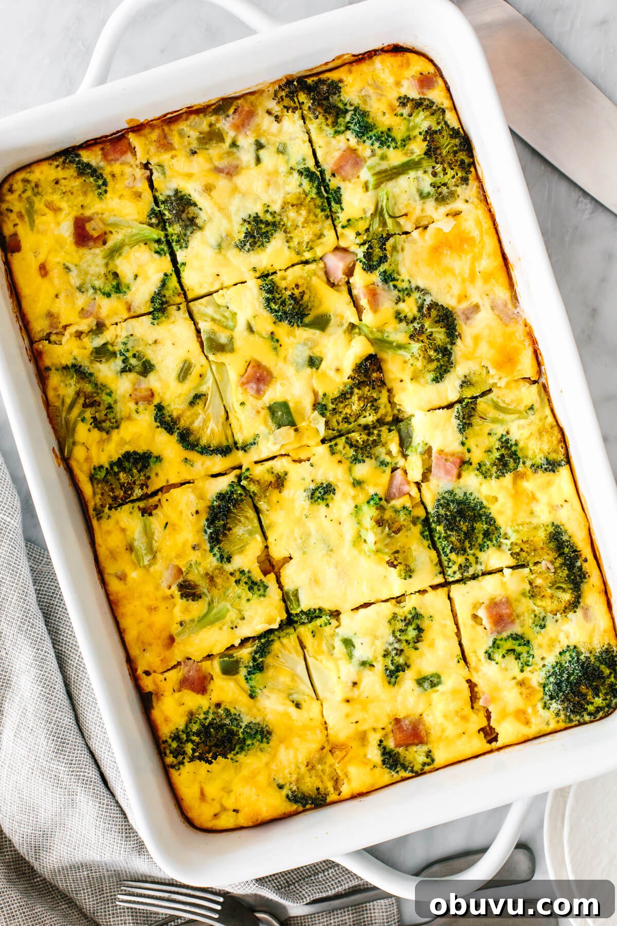 20 High-Protein Breakfast Recipes for Lasting Energy 13 A breakfast casserole next to utensils