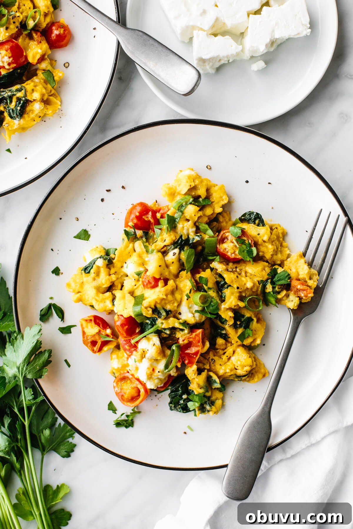 20 High-Protein Breakfast Recipes for Lasting Energy 15 Greek scrambled eggs on a white plate