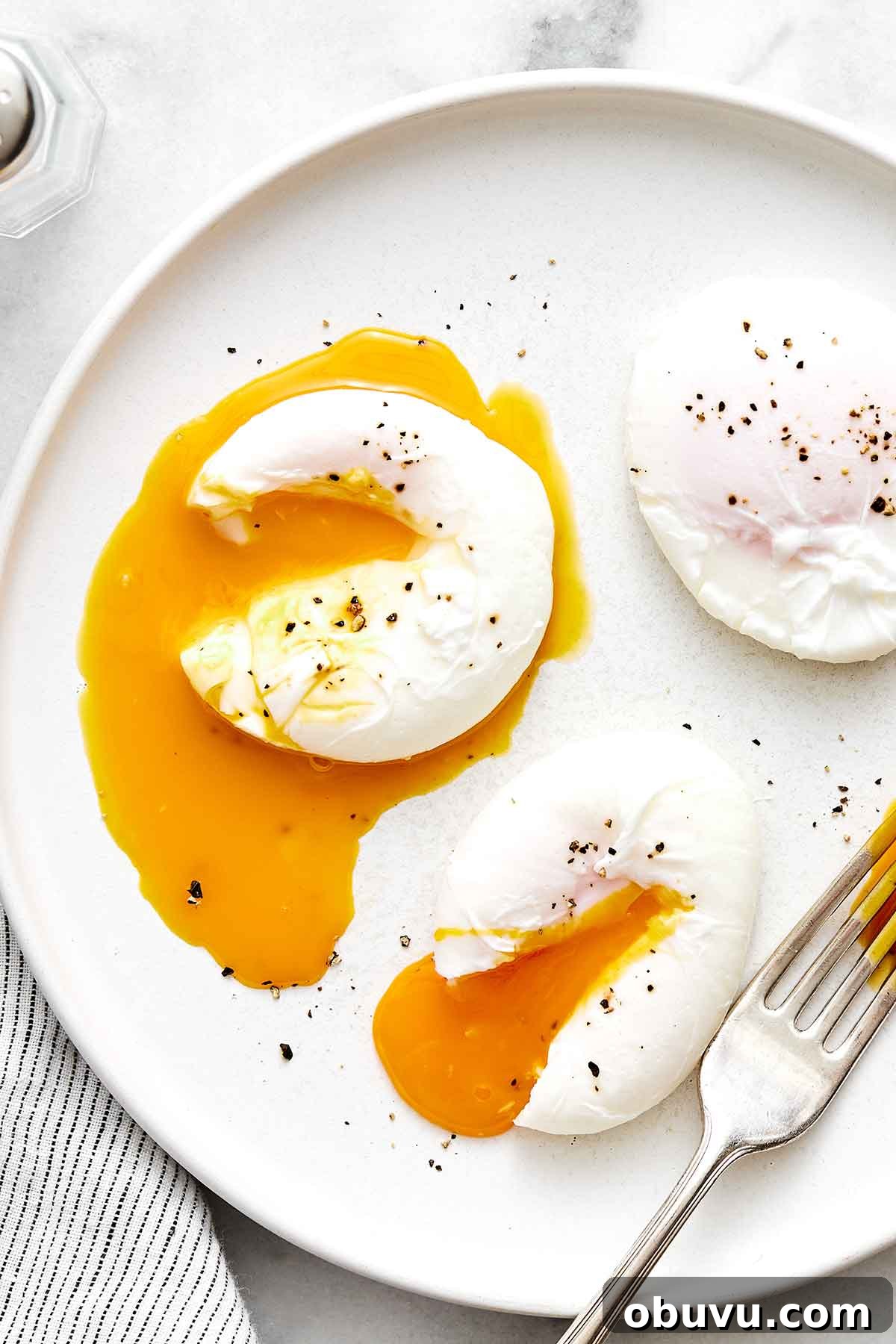 20 High-Protein Breakfast Recipes for Lasting Energy 16 Poached eggs on a plate.