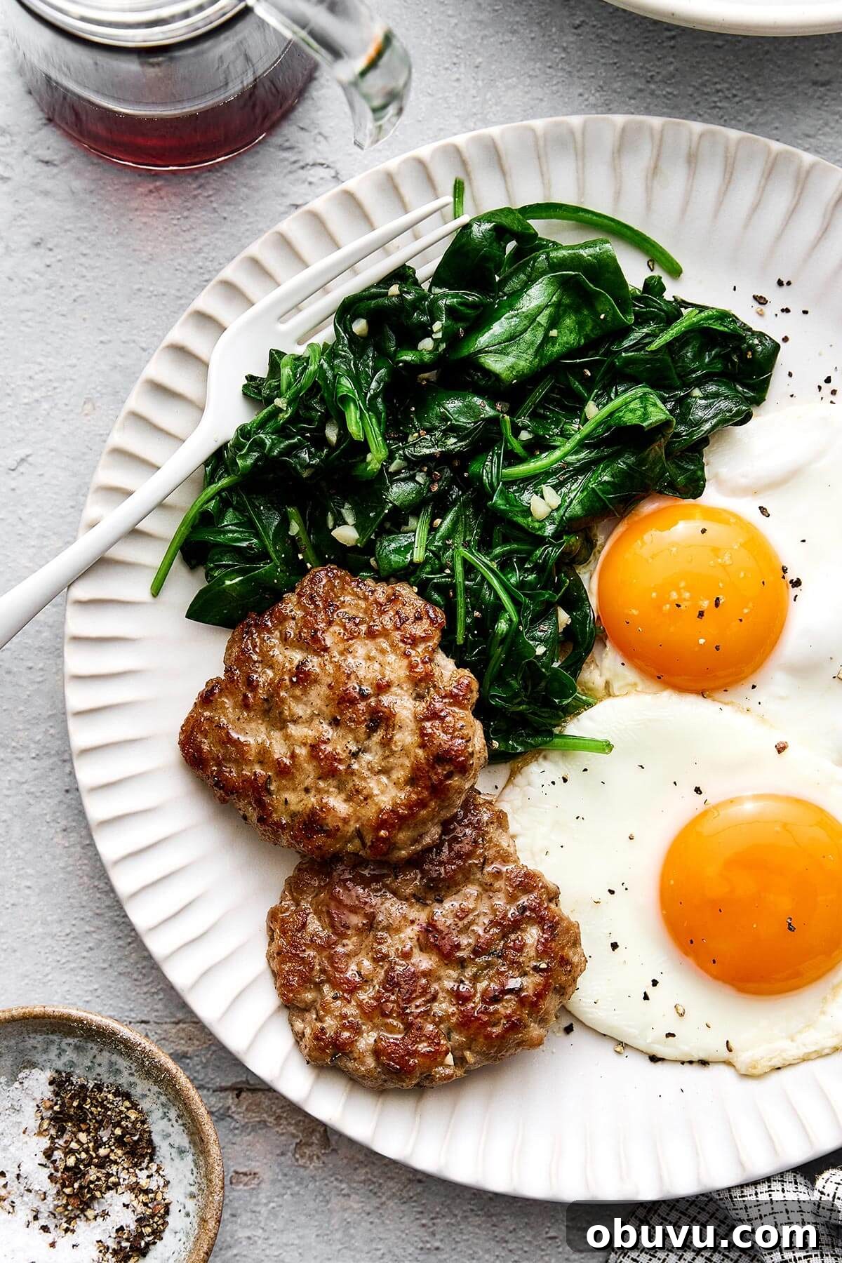 20 High-Protein Breakfast Recipes for Lasting Energy 21 Breakfast plate with eggs, chicken sausage, and spinach.