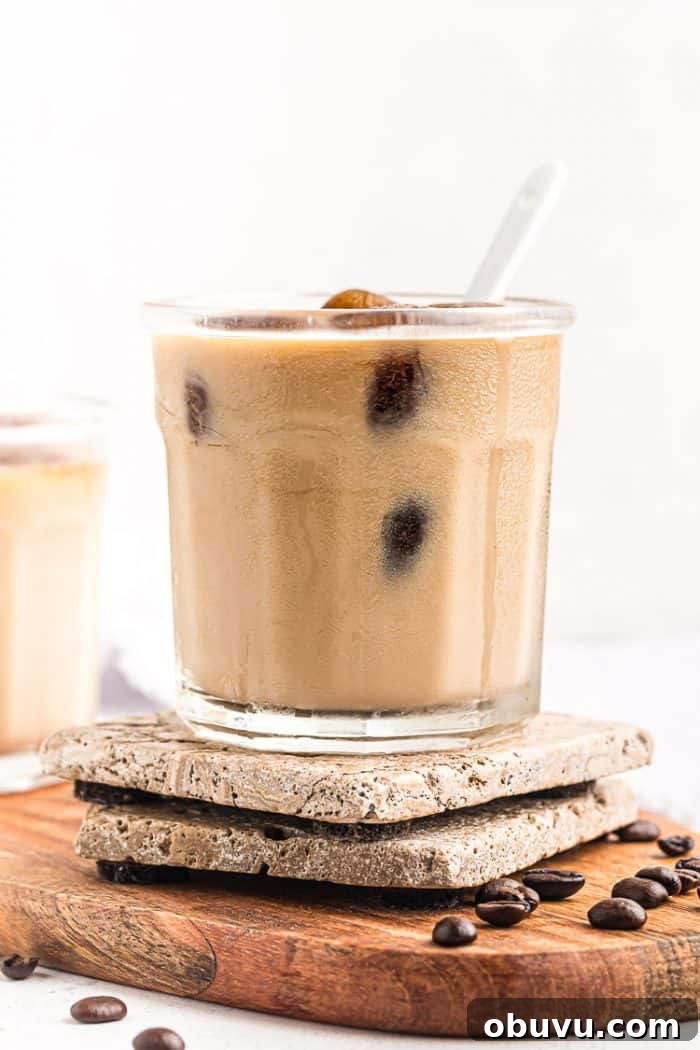 Keto Iced Coffee with 4 Ingredients: Creamy Low-Carb Recipe 2 side view of keto easy iced coffee in a short glass with a spoon sticking out