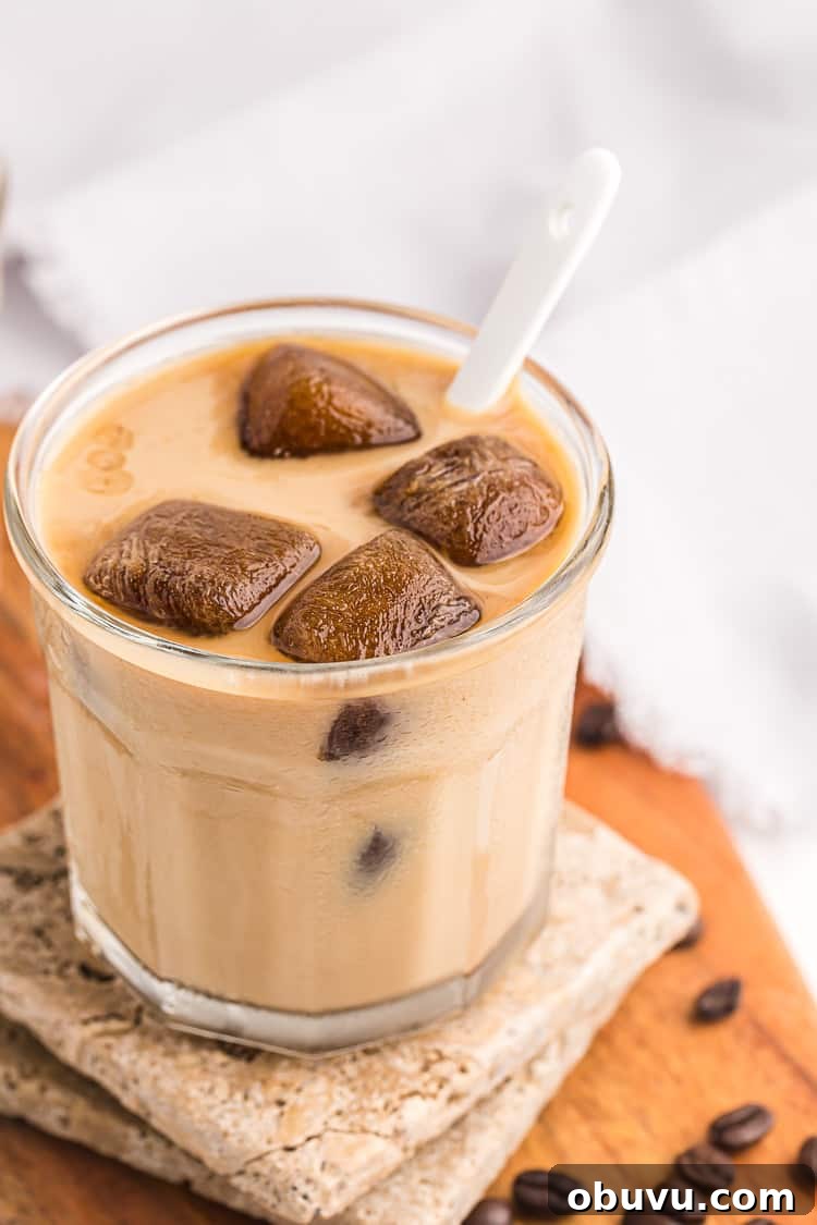 Keto Iced Coffee with 4 Ingredients: Creamy Low-Carb Recipe 11 side view of glass of keto iced coffee with cubes melting in milk