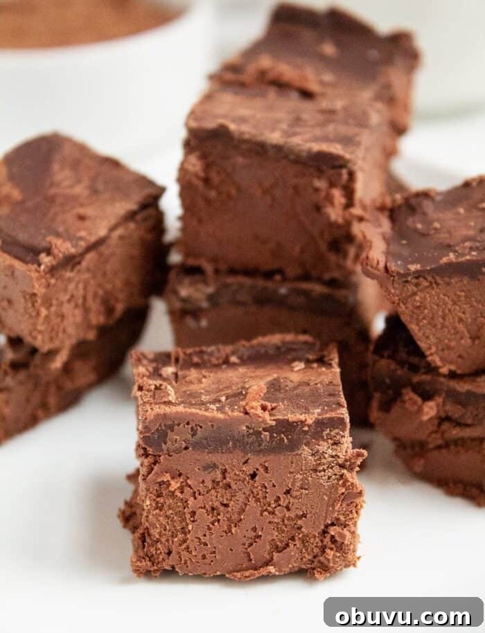 Keto Iced Coffee with 4 Ingredients: Creamy Low-Carb Recipe 14 keto chocolate dessert on a white plate in front of almond milk and cocoa powder in a white bowl