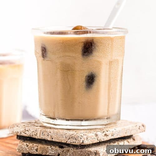 Keto Iced Coffee with 4 Ingredients: Creamy Low-Carb Recipe 18 side view of keto easy iced coffee in a short glass with a spoon sticking out