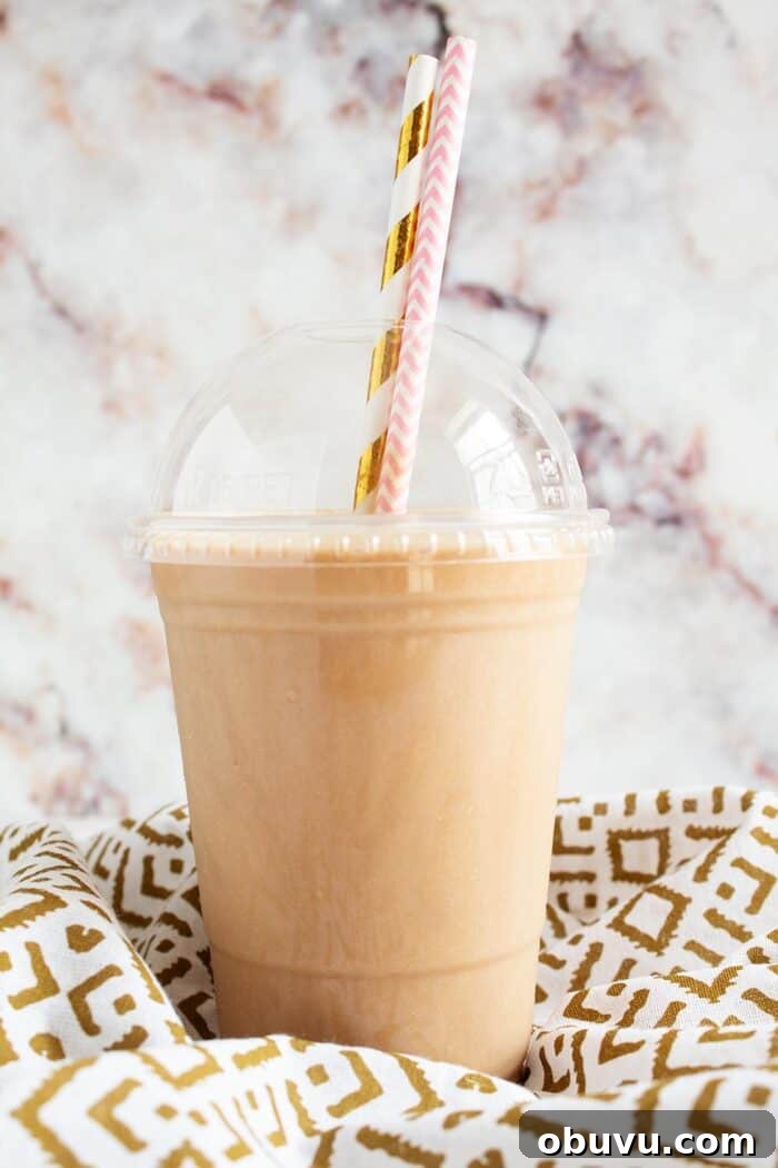 Keto Iced Coffee with 4 Ingredients: Creamy Low-Carb Recipe 6 keto frappuccino in a plastic cup with two decorative straws sticking out