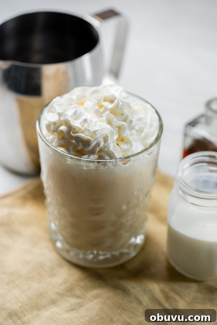 Keto Iced Coffee with 4 Ingredients: Creamy Low-Carb Recipe 10 keto crack coffee keto coffee in a glass with whipped cream on top next to a pitcher