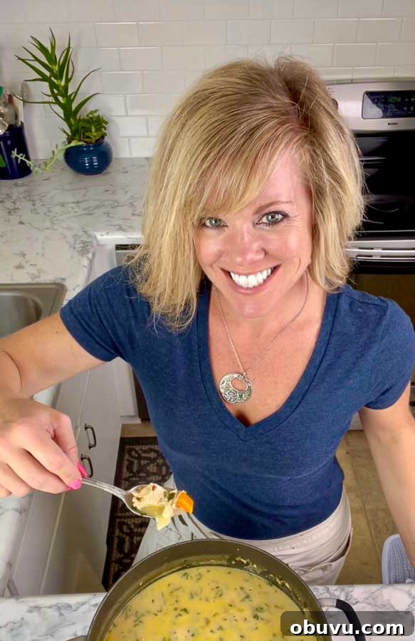 Creamy Turkey and Chicken Soup Recipe for Comforting Meals 3 Jennifer stirring Cream of Turkey Soup and holding a spoon