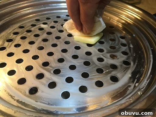 Greasing the Chnöpfli sieve.