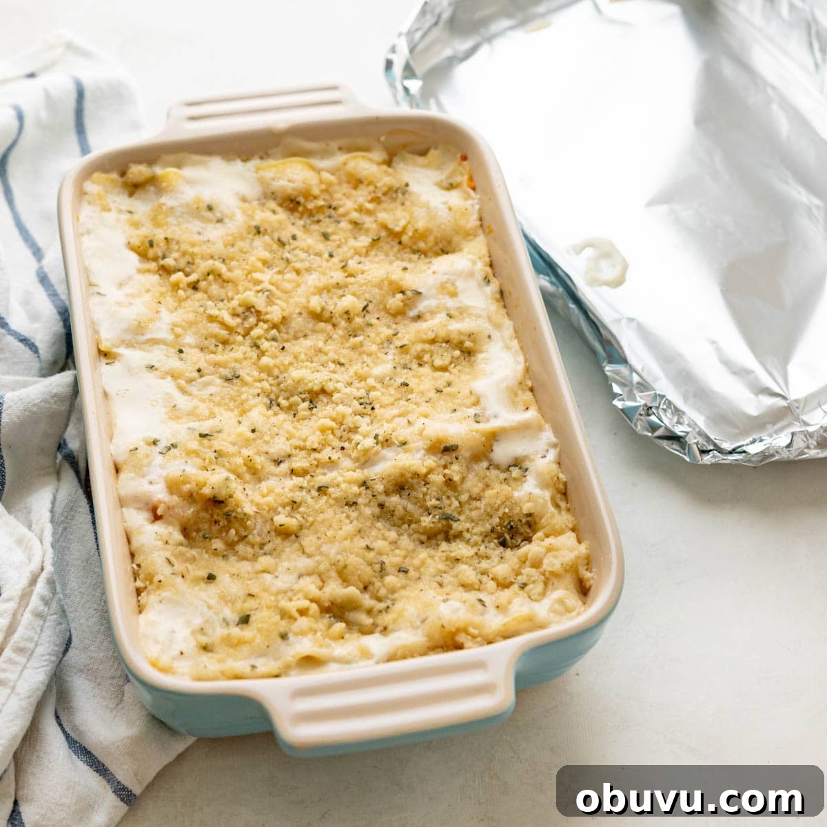 Creamy Butternut Squash Lasagna with Sage and Ricotta 8 butternut squash lasagna after being baked for 45 minutes with a foil cover. It needs more time in the oven to brown.