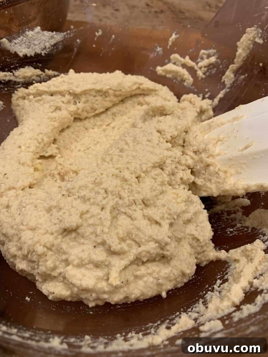 Tamale crust ingredients in a bowl with a spatula.