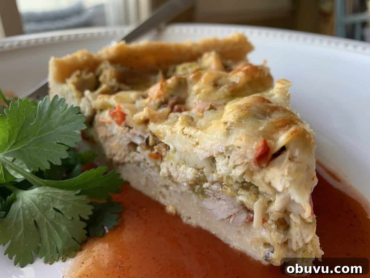 Wedge of tamale casserole on a plate with cilantro garnish.