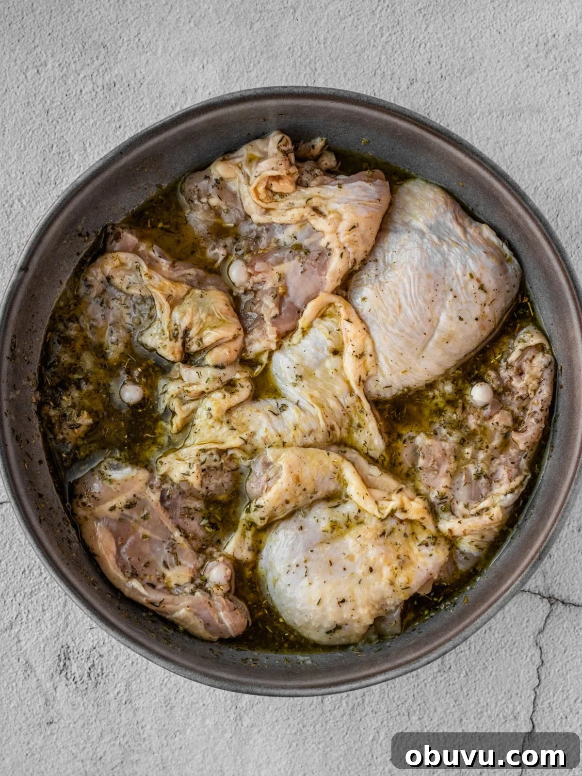 Bowl of chicken thighs marinating.
