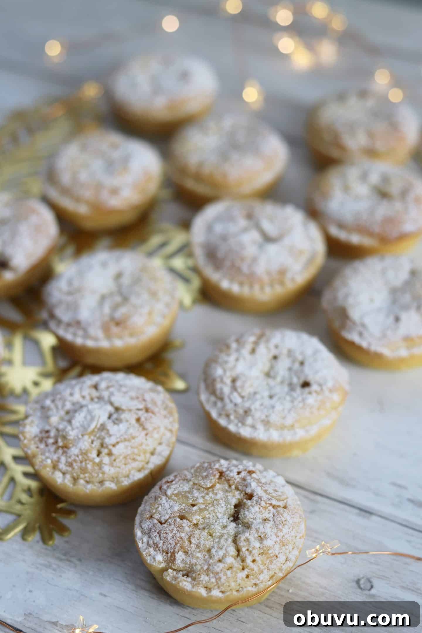 A spread of frangipane mince pies on a white backgroud.