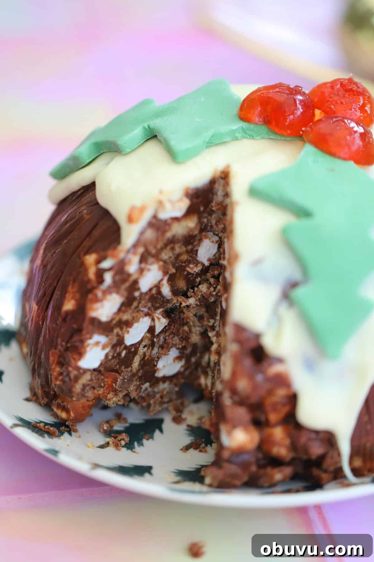 A Christmas pudding rocky road with a slice cut out of it.